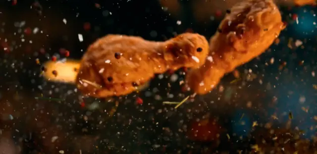 Vliegende kipdrumsticks en kruiden in een gepubliceerd filmbeeld van KFC The Originals – Bucket Cob, geproduceerd door Chuck Studios